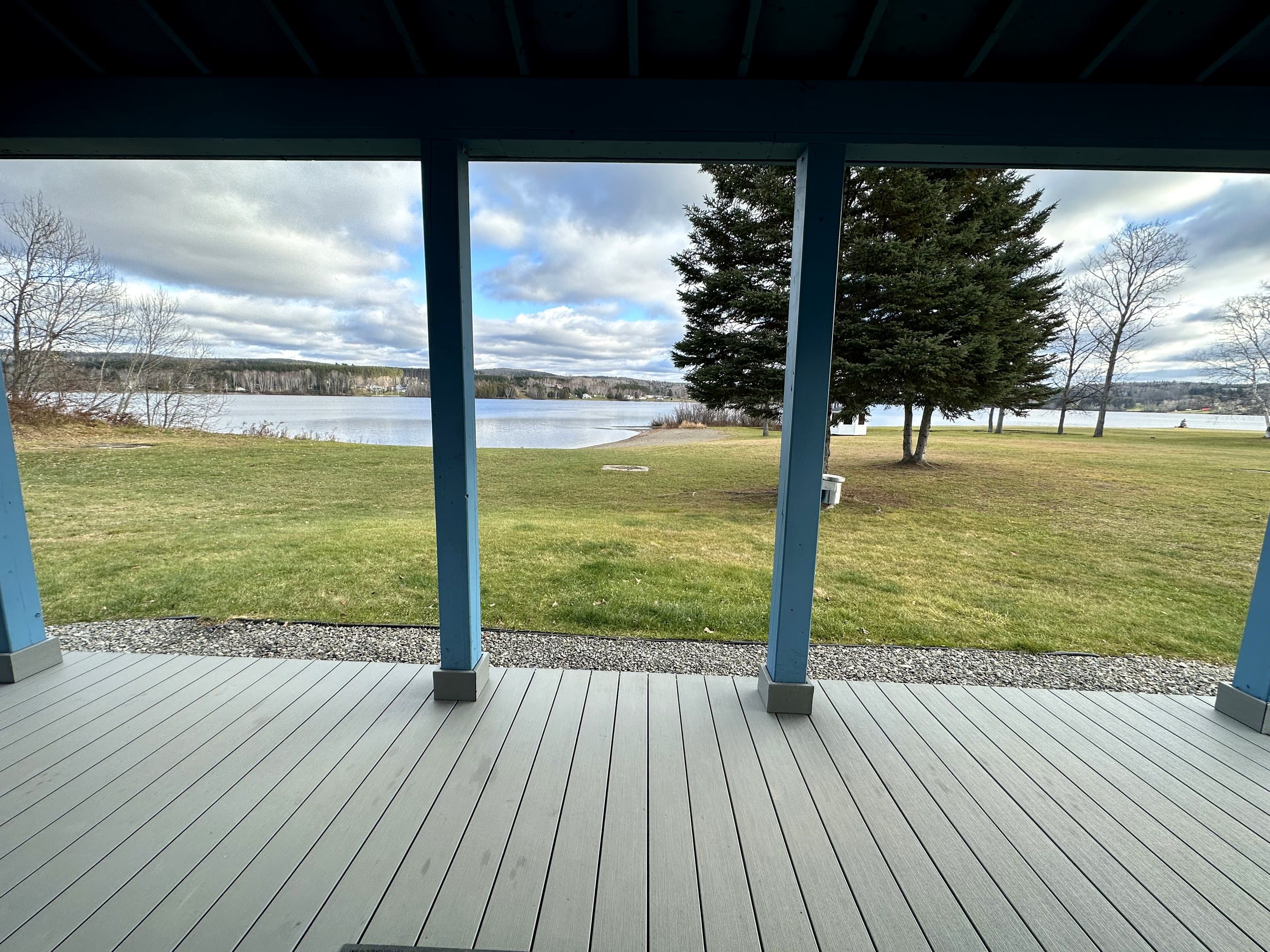 Looking out from a cottage porch across the lawn to Eagle Lake.